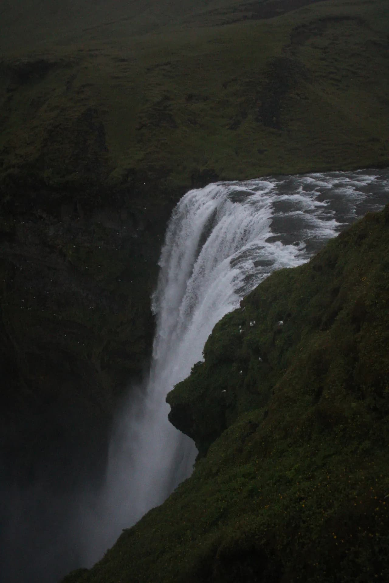 View over the edge of a large waterfall in Iceland